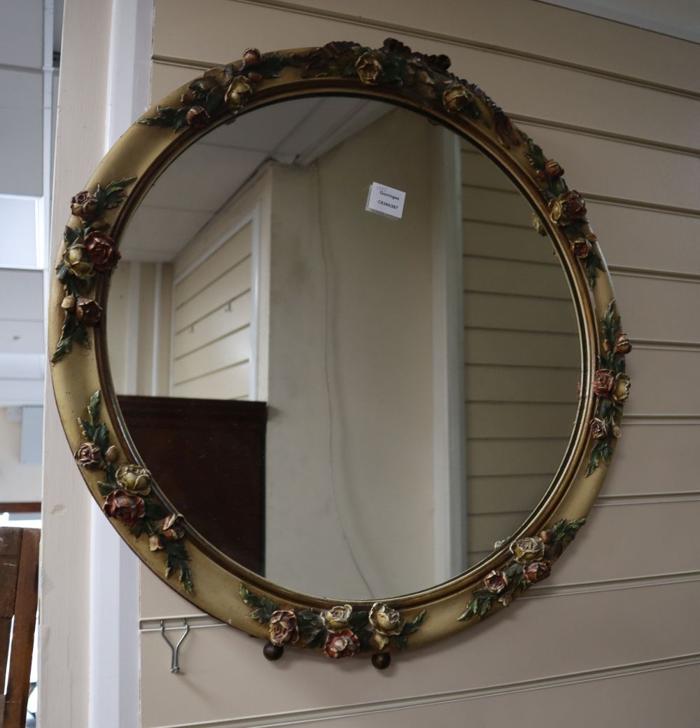 A circular floral moulded mirror, 68cm diameter